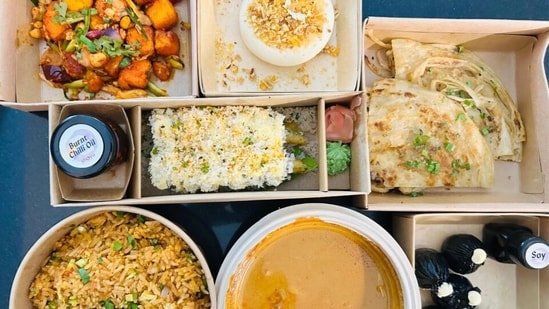 My Shoyu order came with sustainable kraft packaging, labelled boxes, a printed menu, and little jars of burnt chilli oil and soy. Nothing leaked. (Pic: Sanya Panwar)