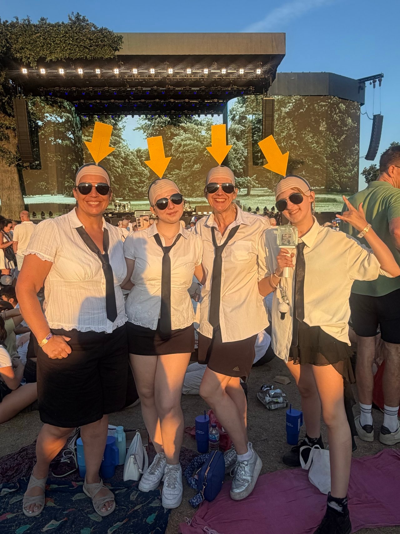 Katie Bale, second from right, and her friends and family added bright yellow arrows to their bald caps.