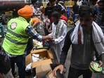 Volunteers distribute food at Jantar Mantar in New Delhi during the ongoing protests.
