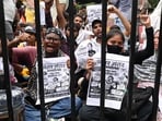 Protesters shout slogans as they carry posters in New Delhi on Wednesday.