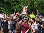 People gather at Sansad Marg to join the Cockroach Janta Party (CJP) protest demanding the resignation of Union Education Minister Dharmendra Pradhan over NEET paper leak issue, in New Delhi.