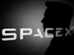 The silhouette of Elon Musk and SpaceX logo are seen in this illustration.(REUTERS)