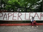 A Cockroach Janta Party (CJP) supporter sits at Jantar Mantar in New Delhi on July 23, 2026 during the ongoing protest to demand the resignation of India's Education Minister Dharmendra Pradhan over alleged NEET exam irregularities.
