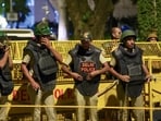 Police and security personnel stand guard during a protest organised by Cockroach Janata Party (CJP) at the Jantar Mantar in Delhi