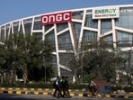 People pass by in front of the Oil and Natural Gas Corporation Limited (ONGC) office in New Delhi