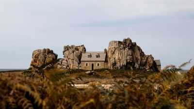 Squeezed between two giant rocks in France, this 160-year-old cottage was built to survive wild ocean storms. (Unsplash) Squeezed between two giant rocks in France, this 160-year-old cottage was built to survive wild ocean storms. (Unsplash)
