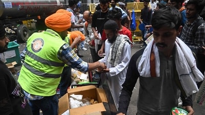 Volunteers distribute food at Jantar Mantar in New Delhi during the ongoing protests. (AFP) Volunteers distribute food at Jantar Mantar in New Delhi during the ongoing protests. (AFP)