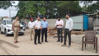 MC Commissioner Ojasvi Alankar along other officials inspecting the ongoing projects to establish e-bus depots at Hambran road and Ghoda colony, in Ludhiana on Thursday. (HT Photo)