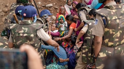 Security personnel remove protesters from the banks of the Barana river, bringing a 15-day agitation against the Ken-Betwa Link and other development projects to an end, in Chhatarpur district, Madhya Pradesh. (PTI) Security personnel remove protesters from the banks of the Barana river, bringing a 15-day agitation against the Ken-Betwa Link and other development projects to an end, in Chhatarpur district, Madhya Pradesh. (PTI)