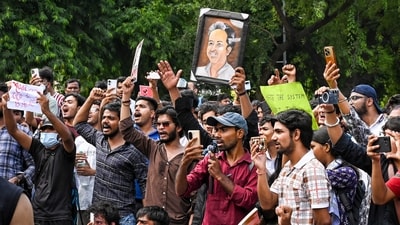 People gather at Sansad Marg to join the Cockroach Janta Party (CJP) protest demanding the resignation of Union Education Minister Dharmendra Pradhan over NEET paper leak issue, in New Delhi. (PTI) People gather at Sansad Marg to join the Cockroach Janta Party (CJP) protest demanding the resignation of Union Education Minister Dharmendra Pradhan over NEET paper leak issue, in New Delhi. (PTI)