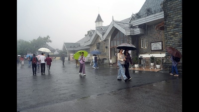 People cover themselves with umbrellas amid rainfall, in Shimla on Thursday. (ANI) People cover themselves with umbrellas amid rainfall, in Shimla on Thursday. (ANI)