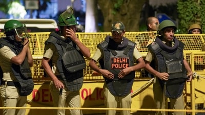 Police and security personnel stand guard during a protest organized by the Cockroach Janata Party (CJP) at Jantar Mantar in Delhi (PTI) Police and security personnel stand guard during a protest organized by the Cockroach Janata Party (CJP) at Jantar Mantar in Delhi (PTI)