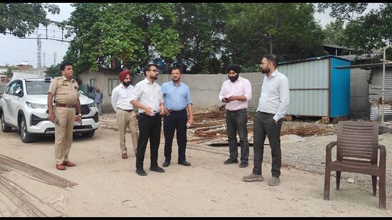 MC Commissioner Ojasvi Alankar along other officials inspecting the ongoing projects to establish e-bus depots at Hambran road and Ghoda colony, in Ludhiana on Thursday. (HT Photo)