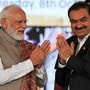 FILE PHOTO: India's Prime Minister Narendra Modi greets Indian businessman Gautam Adani, during the inauguration event of the Navi Mumbai International Airport in Ulwe, Raigad district, India, October 8, 2025. REUTERS/Francis Mascarenhas/File Photo
