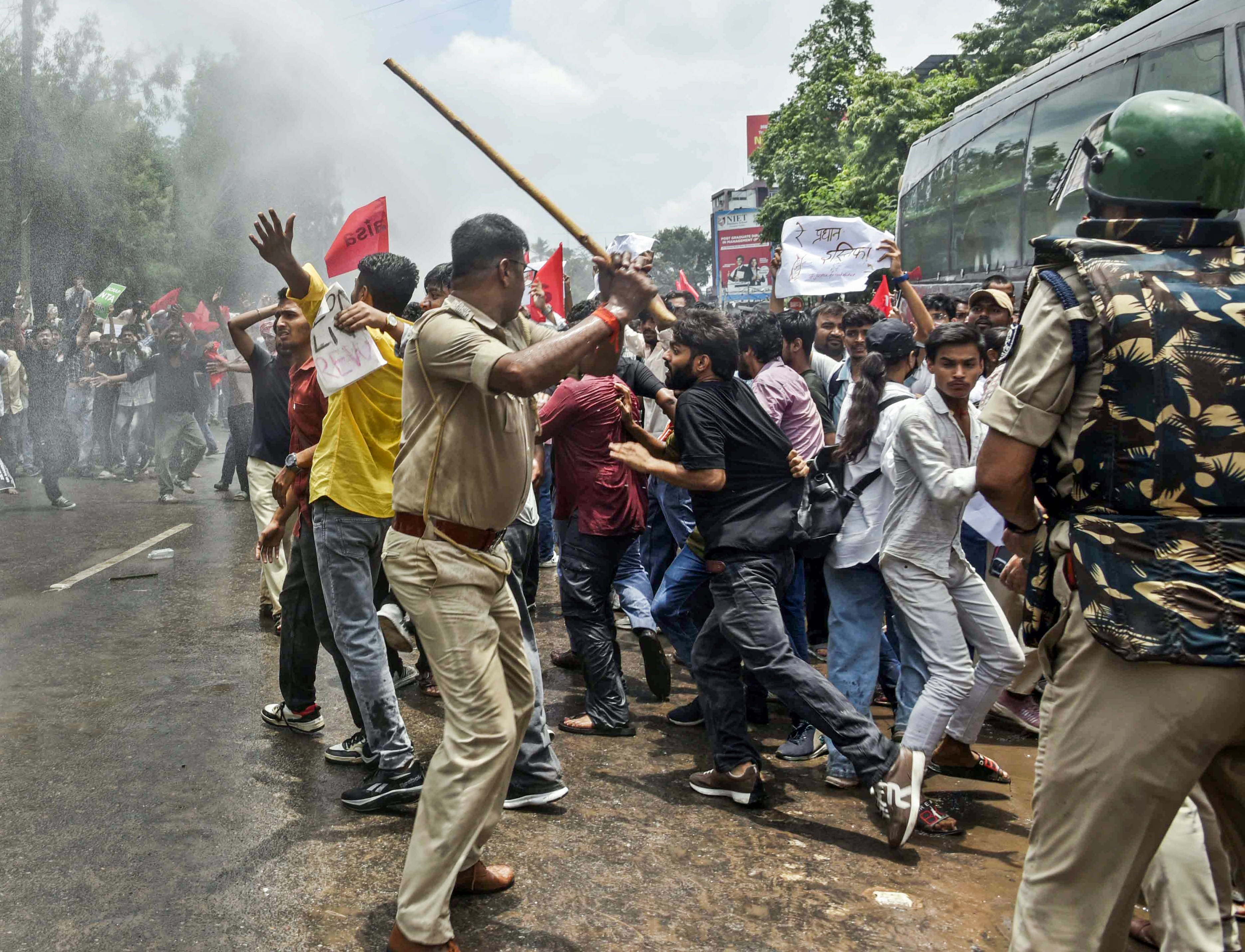 Police personnel carry out a lathi charge on AISA supporters during the Lok Bhawan March against the irregularities and examination paper leaks, in Patna on Wednesday. (ANI) Police personnel carry out a lathi charge on AISA supporters during the Lok Bhawan March against the irregularities and examination paper leaks, in Patna on Wednesday. (ANI)