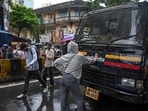 Rhiya Ahir, a 27-year-old model, stands with her arms outstretched in front of a police van during a demonstration in solidarity with the CJP's agitation over the alleged NEET irregularities, in Mumbai, Wednesday, July 22, 2026.