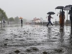 People walk amid rainfall in Shimla, Himachal Pradesh. (PTI)