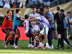 Argentina's Leandro Paredes and Lisandro Martinez clash with Spain's Gavi after the match. 