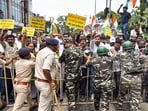Security personnel stand guard as Congress workers march towards the BJP state headquarters during a protest against the detention of Congress MP and Lok Sabha Leader of the Opposition Rahul Gandhi in Ranchi on Thursday. (ANI)