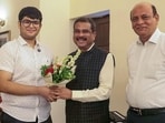 Union education minister Dharmendra Pradhan (centre) with Panshul Bansal of Haryana, who secured AIR 2 in NEET UG 2026. (X)