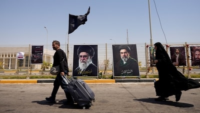 Iranians cross over to Iraq through the Shalamcheh border on July 23. (REUTERS)