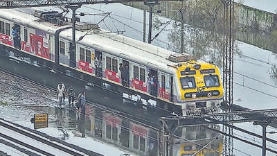 Palghar: Trains run on waterlogged railway tracks after heavy rainfall, in Palghar, Maharashtra, Wednesday, July 8, 2026. (PTI Photo) (PTI07_08_2026_000183B) (PTI)