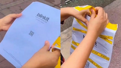 A woman opens a Blinkit packet containing protest posters. (X/@DocRGM_) A woman opens a Blinkit packet containing protest posters. (X/@DocRGM_)