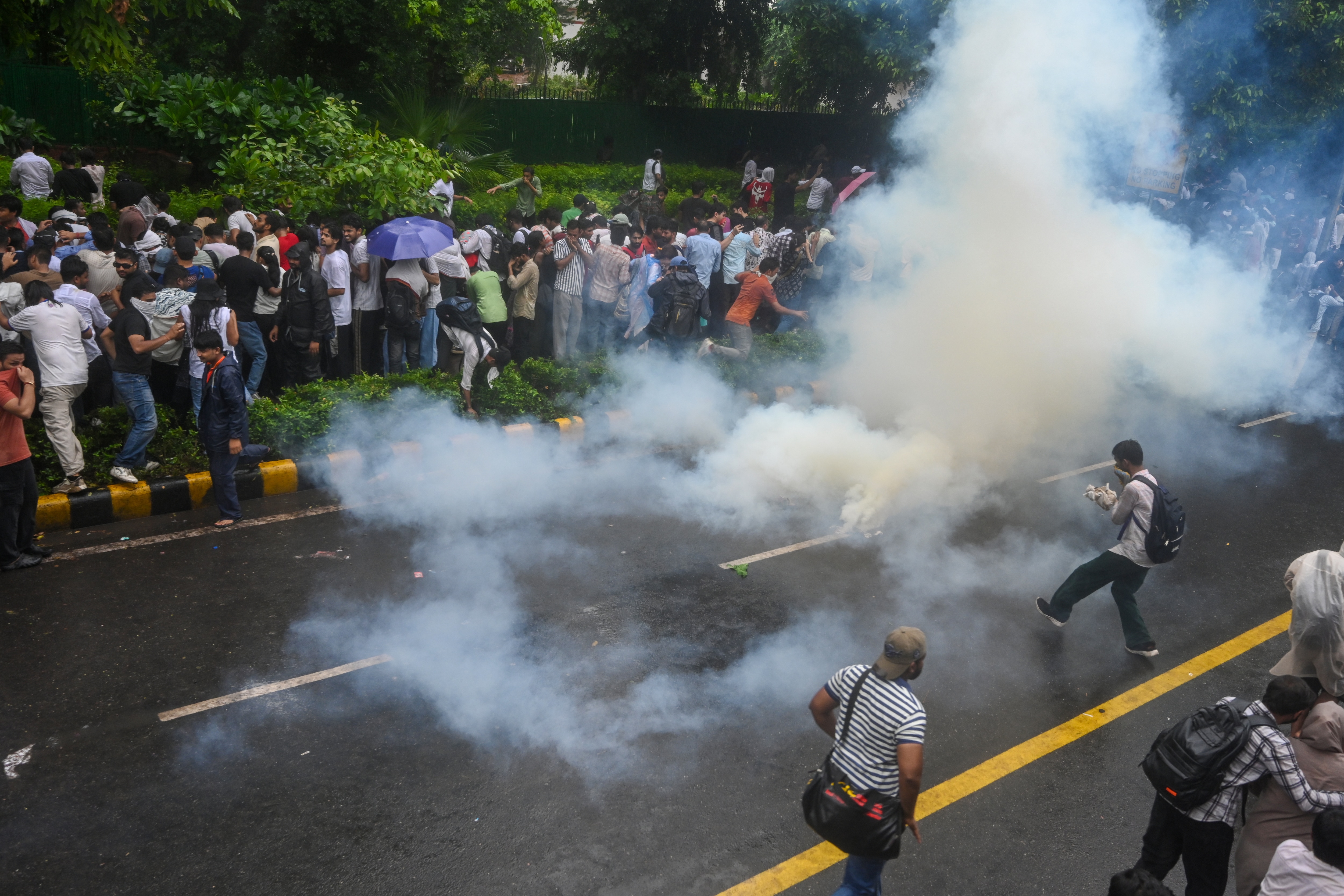Police fire tear gas to disperse protesters during a march towards Parliament demanding the resignation of Federal Education Minister Dharmendra Pradhan on Monday, July 20 (RAJ K RAJ / HT PHOTO)