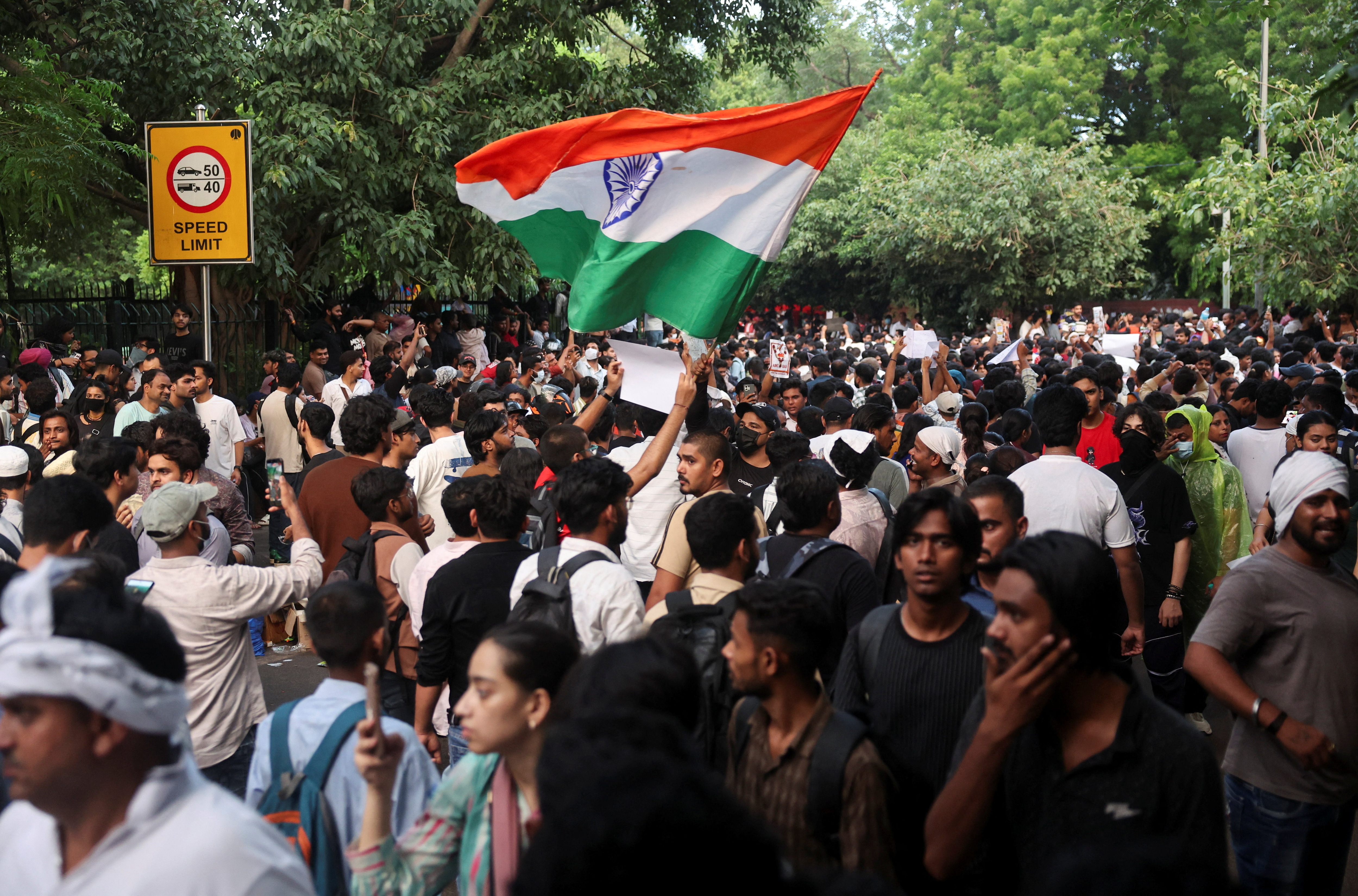 A supporter of India's Cockroach Janata Party (CJP) holds an Indian national flag at the ongoing protest site, a few days after thousands of protesters marched towards parliament demanding the resignation of Education Minister Dharmendra Pradhan over National Eligibility cum Entrance Test (NEET) examination paper leaks, at Jantar Mantar in New Delhi, India, July 23, 2026. REUTERS/Francis Mascarenhas (REUTERS)