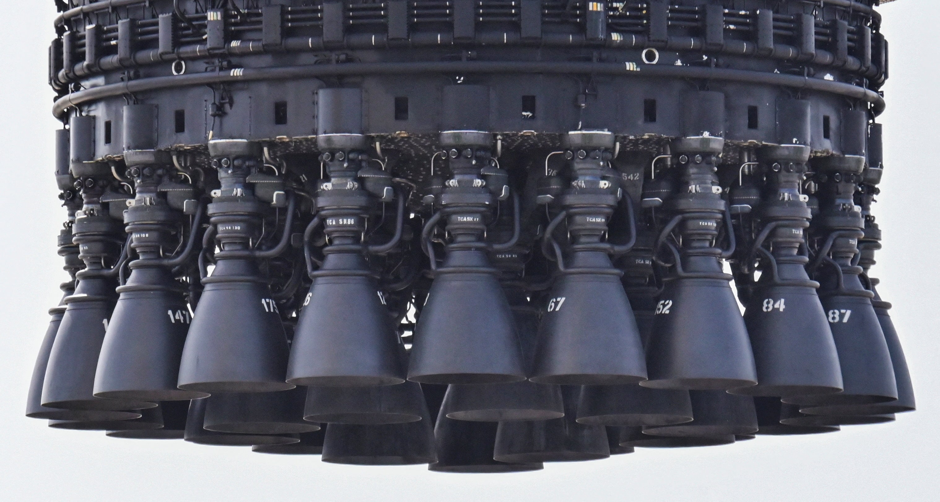 Thirty-three Raptor engines hang from the bottom of Booster 20, in Starbase, Texas, (Reuters)
