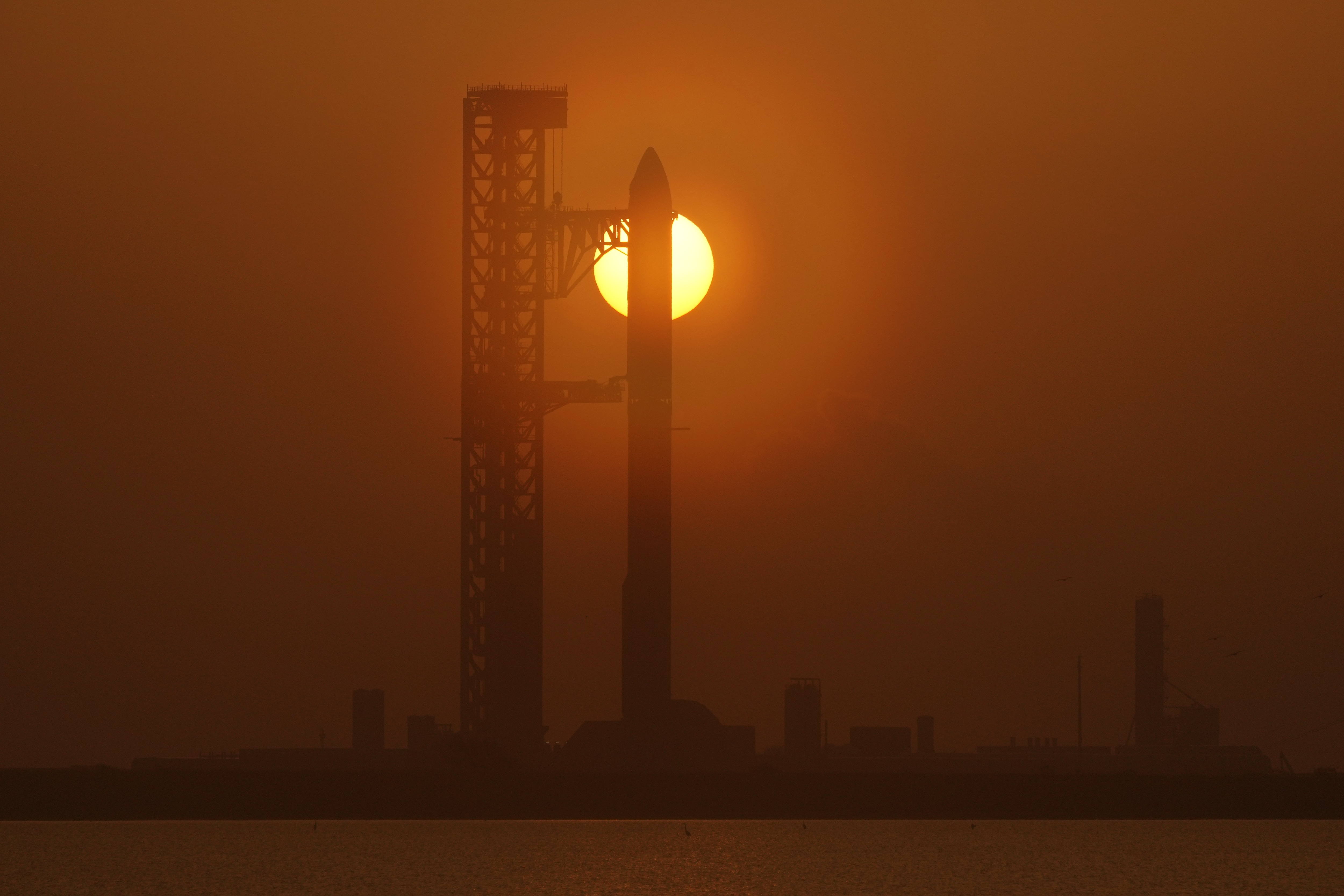 The sun rises behind SpaceX's mega rocket Starship as it is prepared for a test flight from Starbase, Texas. (AP Photo) The sun rises behind SpaceX's mega rocket Starship as it is prepared for a test flight from Starbase, Texas. (AP Photo)