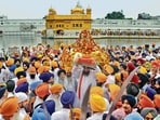 A Sikh priest carries Sri Guru Granth Sahib on his head at the start of the Miri Piri Khalsa march, organised by the SGPC from Akal Takht to commemorate the Miri Piri Diwas in Amritsar on Friday. (ANI)