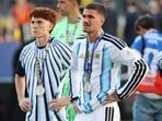 Argentina's Valentin Barco (L) and Argentina's Rodrigo De Paul (R) react during an awards ceremony after Spain won the World Cup final soccer match between Spain and Argentina.