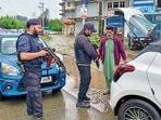 Security personnel check vehicles amid intensified search operations to track down the assailant behind the Anantnag shooting, in Shopian district on Friday. (PTI)