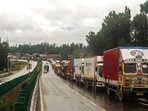 Trucks wait for traffic to resume on the Srinagar–Jammu National Highway due to inclement weather in Anantnag on Friday. (ANI)