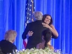 President Donald Trump, left, looks on as CNN's Wolf Blitzer, center, greets fellow CNN correspondent Kaitlan Collins, right, at the White House Correspondents' Association Dinner.