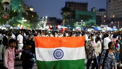 A man holds an Indian national flag as he participates in a demonstration in solidarity with Cockroach Janta Party (CJP) protests held at Jantar Mantar in New Delhi (REUTERS)