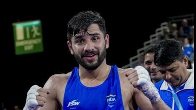 India's Sachin Siwach celebrates after winning the men's 60kg Round of 32 boxing match against Canada's Keoma Al-Ahmadieh during the 23rd Commonwealth Games, in Glasgow. (PTI)