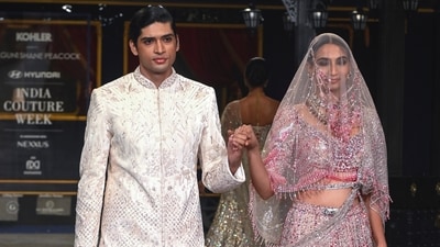 The collection featured sculptured corsets, sweeping capes, front-open embroidered sherwanis, sharply tailored bandhgalas, dramatic trains, and intricately embellished evening, and bridal wear. (PTI) The collection featured sculptured corsets, sweeping capes, front-open embroidered sherwanis, sharply tailored bandhgalas, dramatic trains, and intricately embellished evening, and bridal wear. (PTI)