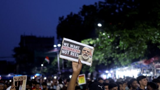 A man in Kolkata holds up a poster asking PM Modi to resign as he participates in a demonstration held in solidarity with Cockroach Janta Party (CJP) at Jantar Mantar in New Delhi.