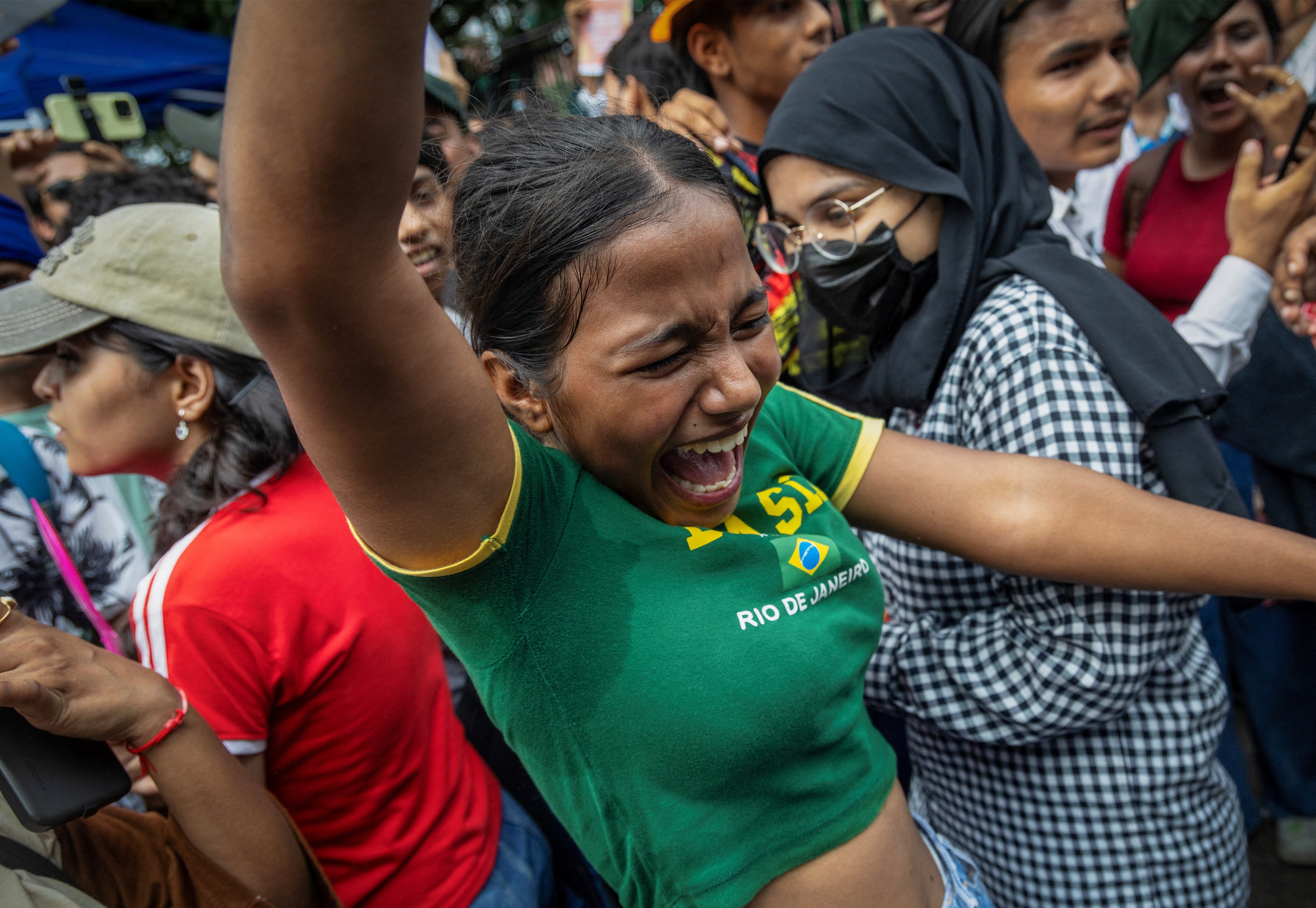 Protesters at the Cockroach Janta Party's site at Jantar Mantar in Delhi celebrate after Dharmendra Pradhan resigned. (Reuters Photo)