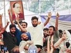 Cockroach Janta Party (CJP) Founder Abhijeet Dipke celebrates after Union Education Minister Dharmendra Pradhan resigned and took responsibility for the NEET paper leak, at Jantar Mantar in New Delhi.