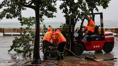 Workers clear fallen debris and obstacles from the road after Typhoon Noul, in Hong Kong, China, July 26, 2026. (REUTERS)
