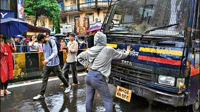 Mumbai: Rhiya Ahir, a 27-year-old model, stands with her arms outstretched in front of a police van during a demonstration in solidarity with the CJP's agitation over the alleged NEET irregularities, in Mumbai, Wednesday, July 22, 2026. (PTI) Mumbai: Rhiya Ahir, a 27-year-old model, stands with her arms outstretched in front of a police van during a demonstration in solidarity with the CJP's agitation over the alleged NEET irregularities, in Mumbai, Wednesday, July 22, 2026. (PTI)