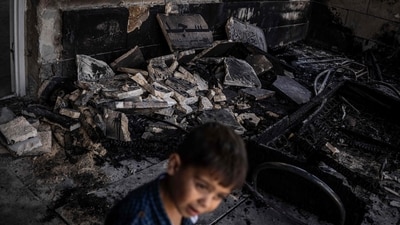 A young Palestinian boy walks in front of a mosque allegedly burned by Israeli settlers in the village of Qusra, south of Nablus in the Israeli-occupied West Bank on July 26, 2026. (AFP) A young Palestinian boy walks in front of a mosque allegedly burned by Israeli settlers in the village of Qusra, south of Nablus in the Israeli-occupied West Bank on July 26, 2026. (AFP)