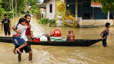 People move their belongings to a safer place on a boat after floods and heavy rains, in Sivasagar, Assam. (PTI) People move their belongings to a safer place on a boat after floods and heavy rains, in Sivasagar, Assam. (PTI)