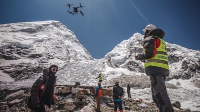 An operator uses a heavy-lift drone to clear trash from the Everest base camp.