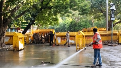 An NDMC worker washes the road during a cleanliness drive at the protest site of Jantar Mantar, in New Delhi on Saturday. (PTI) An NDMC worker washes the road during a cleanliness drive at the protest site of Jantar Mantar, in New Delhi on Saturday. (PTI)