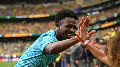 Vinicius Junior high fives a fan during the warm up before the match. (REUTERS)