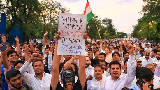 Congress leaders and workers take out a 'Vijay March' after Union Education Minister Dharmendra Pradhan resigns, taking responsibility for the NEET paper leak, at Statue Circle, in Jaipur, Rajasthan, Saturday, July 25, 2026.